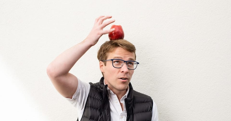 A photo of Josh balancing an apple on his head.